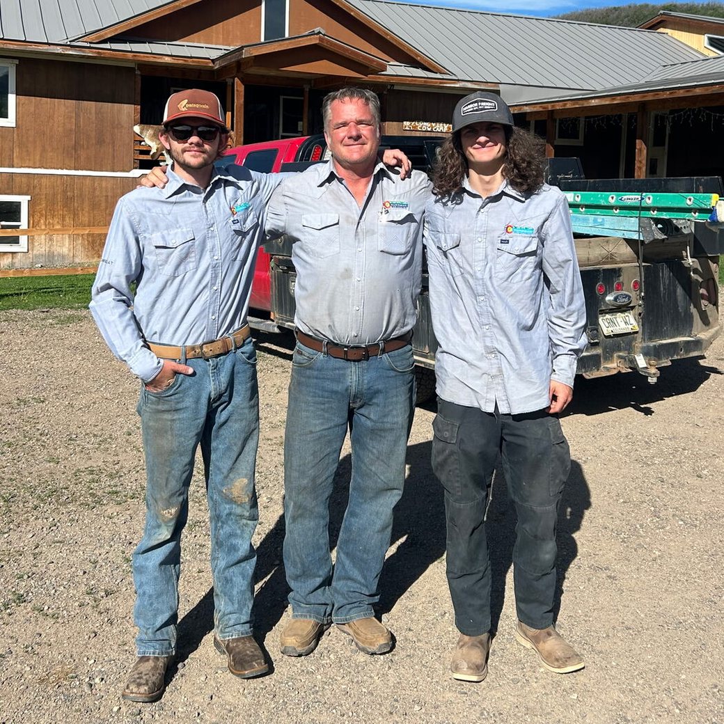 Donnie Kuntz of Current Electric with his sons Dylan and Degan in front of a company work truck