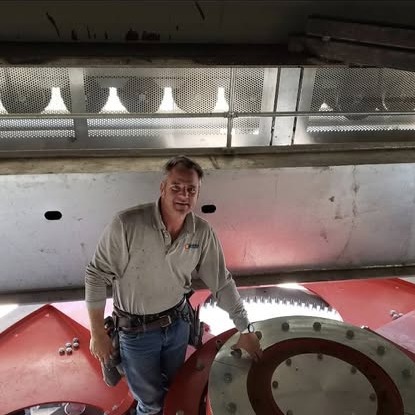 An electrician standing among drive equipment inside a Steamboat Resort chairlift terminal